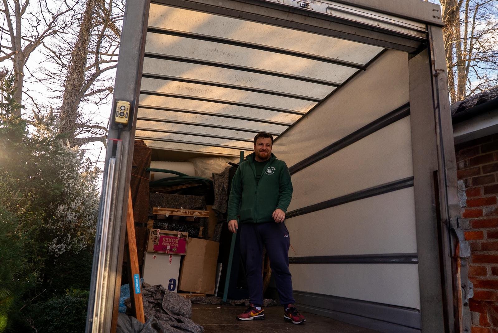 White Glove Surrey mover standing inside a loaded removals van