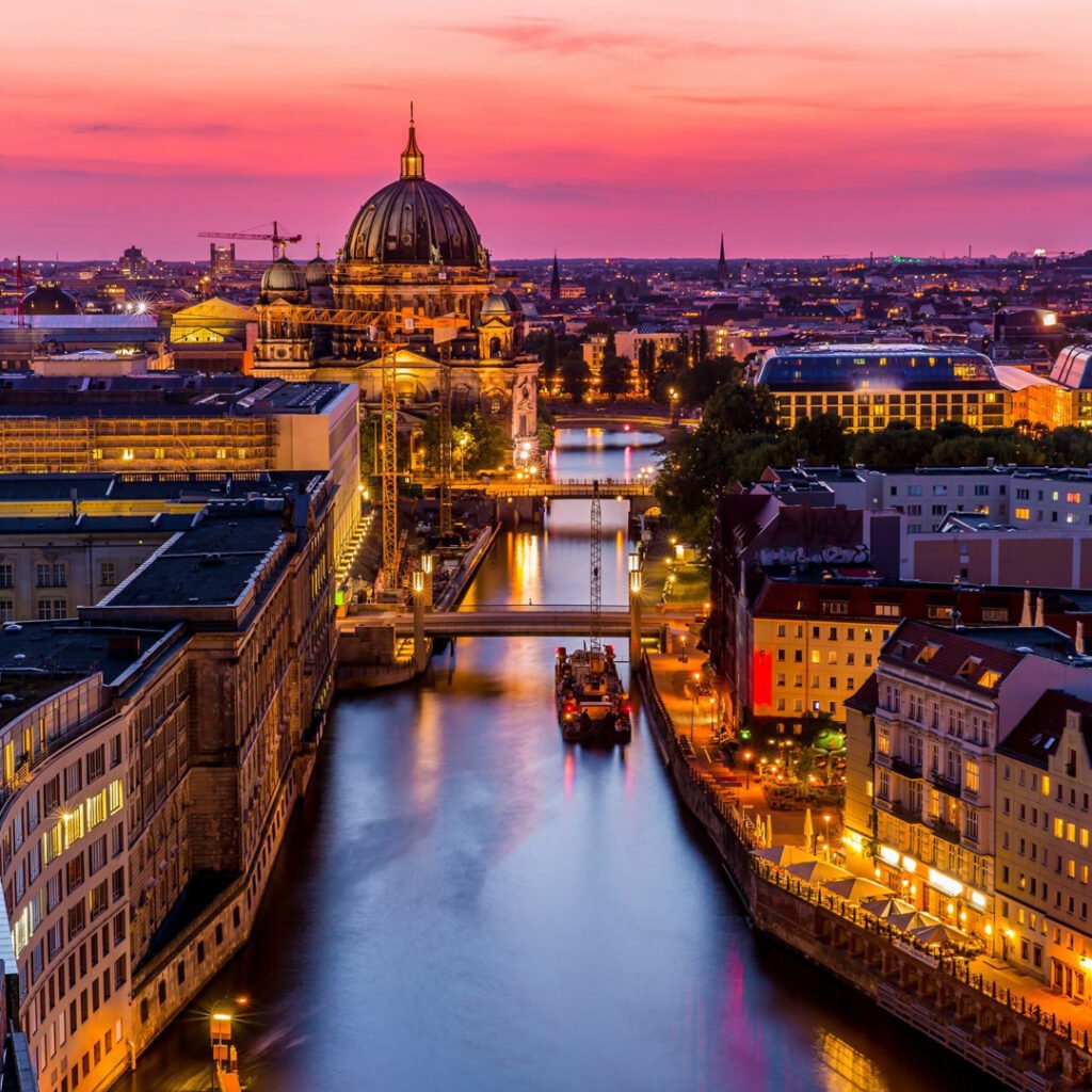 European city skyline and river at dusk