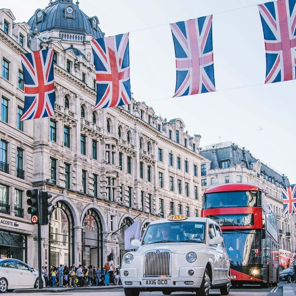 London street with a red bus, taxi and Union flags