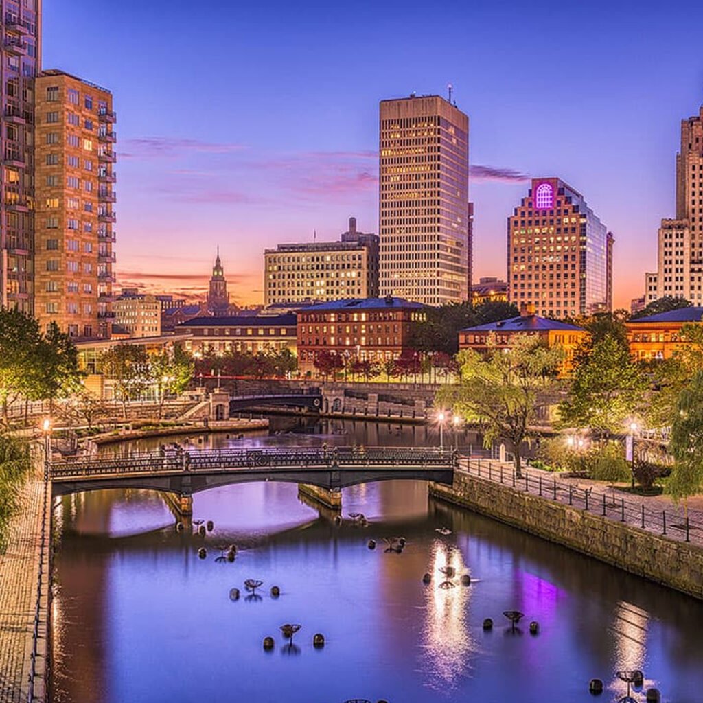 US city skyline with river bridges at sunset