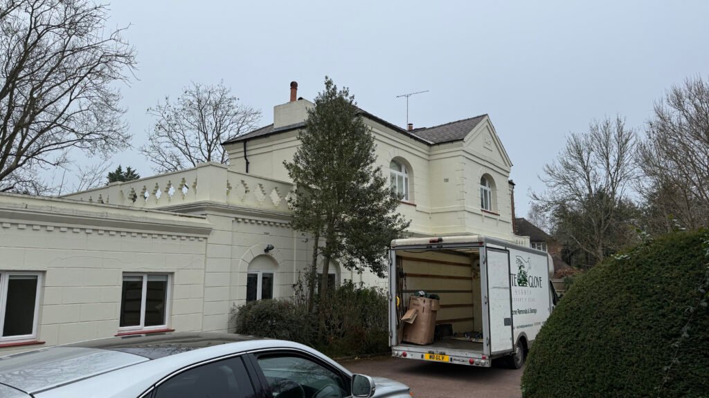 White Glove Surrey removals van outside a large home