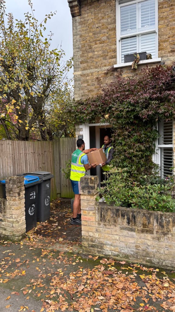 White Glove Surrey movers carrying a box into a home
