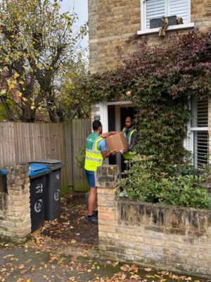307 White Glove Surrey movers carrying a box into a home