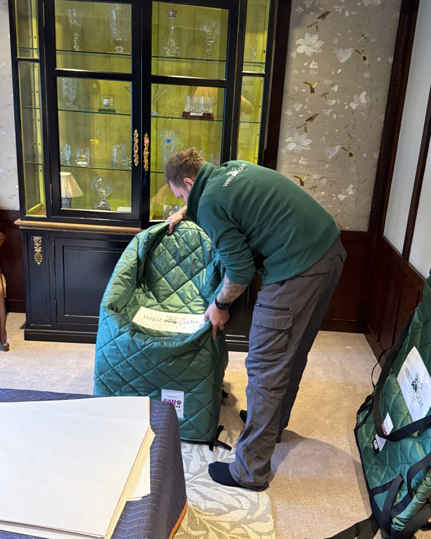 White Glove Surrey mover placing a chair in a padded cover